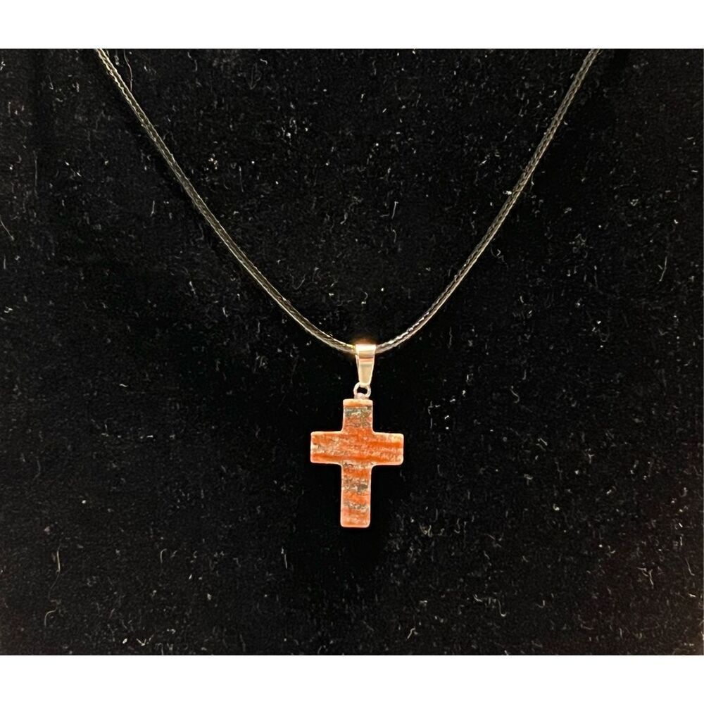 Tan and Red Stone Cross on a Black Necklace Cord